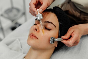 Woman receiving facial massage in beauty salon.