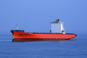 Container ship in ballast condition. Blue background of sea and sky.