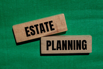 Estate planning words written on wooden blocks with green background. Conceptual estate planning...