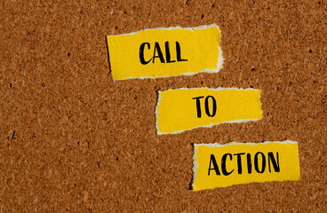 Call to action words written on ripped yellow paper pieces with brown background. Conceptual call...
