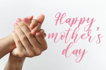 hand of child and mother on white background text happy mother's day, sweet wishes concept