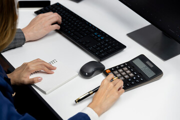 Cropped hands businessman with coworker calculating with calculator manual's financial and...