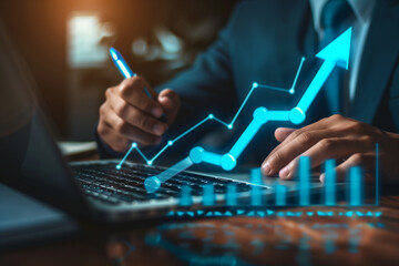 Businessman using a laptop and holding a pen to write on a virtual screen