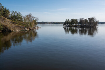 Concept of lonely island landscape: Kaninholmen - Swedish island,  lonely island surrounded by water, beautiful place on sunny evening