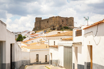a street in Segura de Leon with a view to the castle, comarca of Tentudia, province of Badajoz, Extremadura, Spain