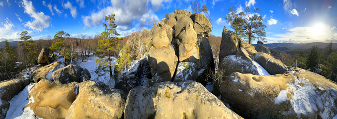 Dovbush rocks in winter in Bubnyshche, Carpathians, Ukraine, Europe. Huge stone giants rise in the snowy transparent beech forest, all-round panoramic views are unique without leaves