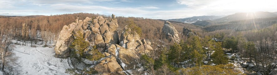 Dovbush rocks in winter in Bubnyshche, Carpathians, Ukraine, Europe. Huge stone giants rise in the snowy transparent beech forest, all-round panoramic views are unique without leaves