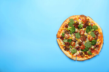 Delicious vegetarian pizza with mushrooms, vegetables and parsley on light blue background, top view. Space for text