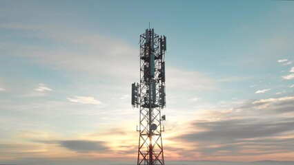 Futuristic 5G telecommunication tower against beautiful sky at sunset