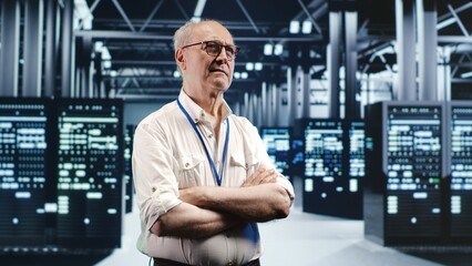 Portrait of elderly engineer looking around modern server room in data center, preparing to start comission on malfunctioning high tech facility hardware rigs in order to ensure errorless operations
