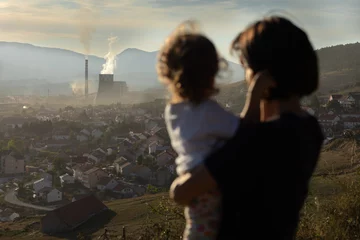 big chimney smoke over the city. Polluted environment. Mother with children watching chimney pollution environment. © Visual Intermezzo