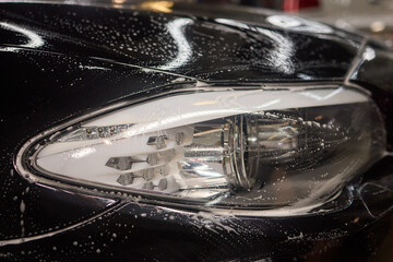 Foam covers car in garage tires, wheels, lights, hood, automotive design