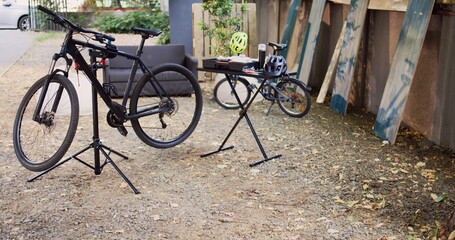 View of modern damaged bikes placed and secured in home yard ready for maintenance with...