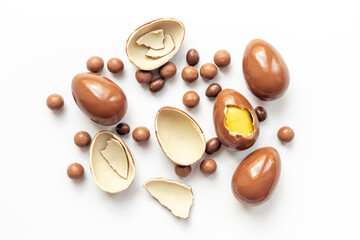 Chocolates background with chocolate eggs and sweets, top view