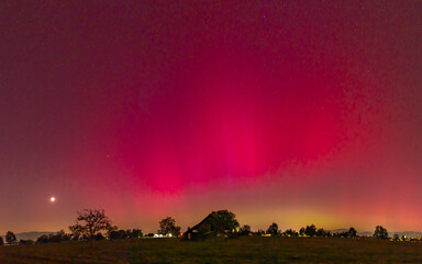 Dornbirn, Vorarlberg, Austria - 05.10.2024, 22:25, amazing red northern lights over the town of...