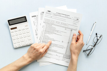 Fototapeta premium Tax forms 2024 with the calculator. Income Statement. Paying the tax rate