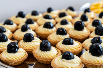 coffee break hotel during conference meeting, corporate revent with tea and coffee catering, decorated catering banquet table with variety of different pastry and bakery, with croissants and cookies