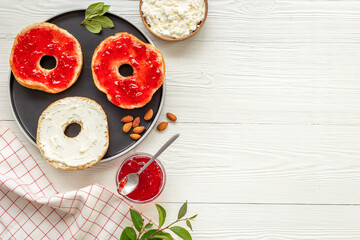Set of fresh bread bagels with with berry jam and cheese cream. Healthy breakfast