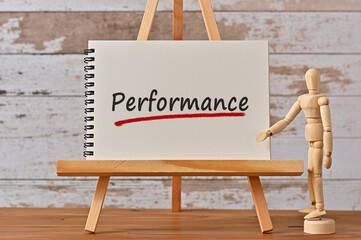 There is notebook with the word Performance. It is as an eye-catching image.