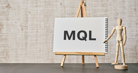 There is notebook with the word MQL. It is an abbreviation for Marketing Qualified Lead as...
