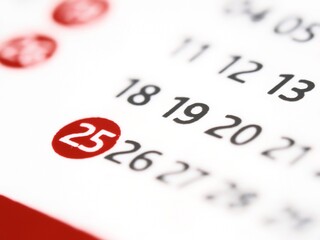 White paper calendar with the number 25 twenty-five in a red circle. The 25th twenty-fifth day of the month on a calendar