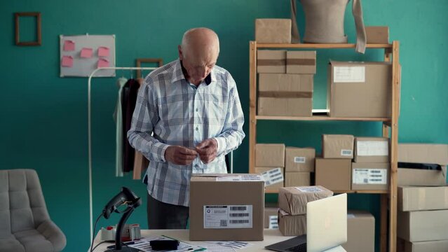 Startup small business SME, Entrepreneur owner old man to preparing pack product box for online parcel delivery.