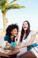 Group of multiethnic young people hanging out outdoors. Young multiracial women having fun while enjoying holidays with friends - Female friendship concept