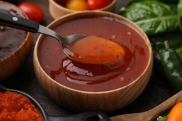 Taking homemade marinade from bowl at table, closeup