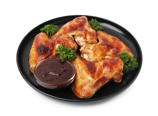 Plate with marinade and chicken wings isolated on white