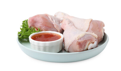 Fresh marinade, raw chicken drumsticks and lettuce isolated on white