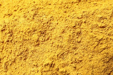 Dry curry powder as background, top view
