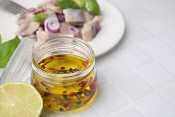 Tasty fish marinade in jar on light tiled table, closeup. Space for text