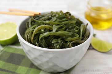 Tasty seaweed salad in bowl served on table, closeup