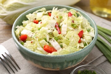 Tasty salad with Chinese cabbage in bowl on table, closeup