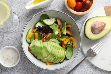Healthy dish high in vegetable fats served on light textured table, flat lay