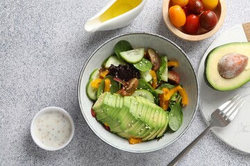Healthy dish high in vegetable fats served on light textured table, flat lay