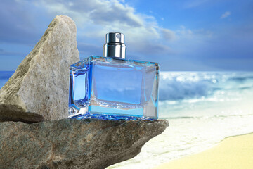 Bottle of aquatic perfume on rock near ocean. Fresh sea breeze scent
