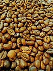 A closeup of coffee beans, showcasing their rich color and texture.