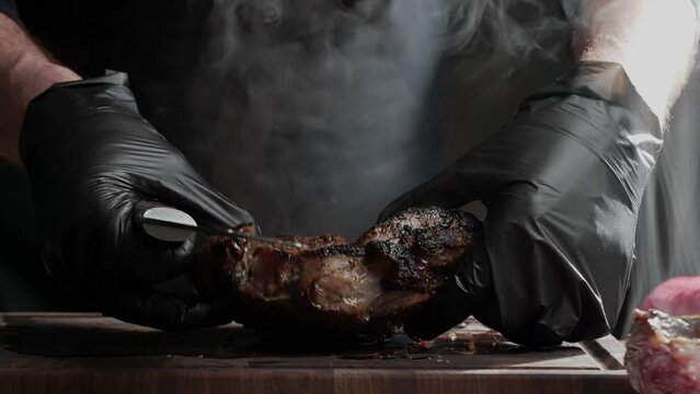 A person is slicing a piece of meat on a magenta cutting board, preparing food for a cooking event. The art of cooking involves skillfully cutting and slicing ingredients to create a delicious recipe