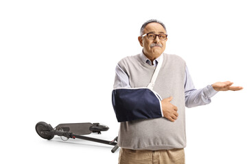 Unhappy mature man with a broken arm injured from an electric scooter