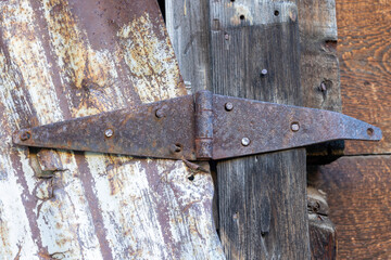 Old worn hinge on barn