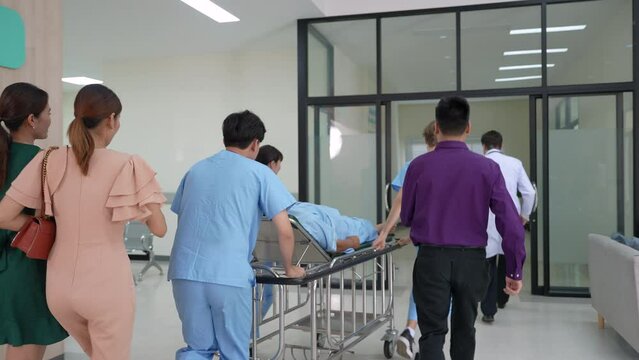 Professional medical team doctor give advice to relative family of senior patient after surgeon from operating room, physician specialties with stethoscope and white coat diagnose heart attack symptom
