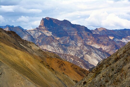View of picturesque mountain landscape as seen from the hiking trail crossing the Ganda La pass (4980 m) and leading to Markha valley (Hemis National Park, Ladakh, India)