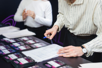 Process of checking in on a conference congress forum event, registration desk table, visitors and attendees receiving a name badge and entrance wristband bracelet and register electronic ticket