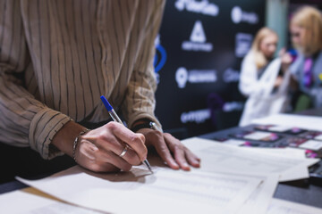 Process of checking in on a conference congress forum event, registration desk table, visitors and...