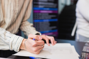 Process of checking in on a conference congress forum event, registration desk table, visitors and attendees receiving a name badge and entrance wristband bracelet and register electronic ticket
