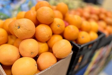 Box with ripe fresh organic tangerines on the shelf of a fruit supermarket are displayed for sale....