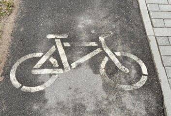 A bike path in the park with a marking in the form of a bicycle image. A sporty lifestyle