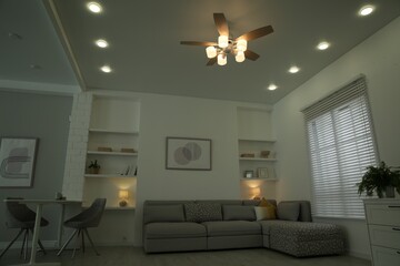 Ceiling fan, furniture and accessories in stylish living room, low angle view