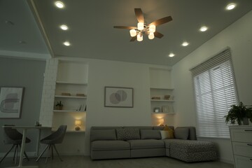 Ceiling fan, furniture and accessories in stylish living room, low angle view